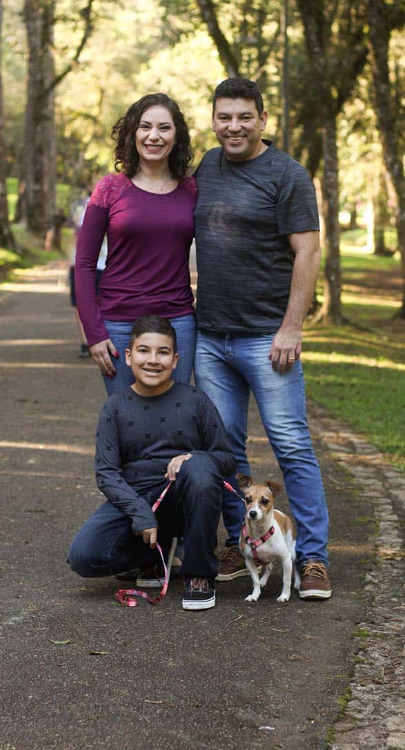 familia posando en un parque con su perrito
